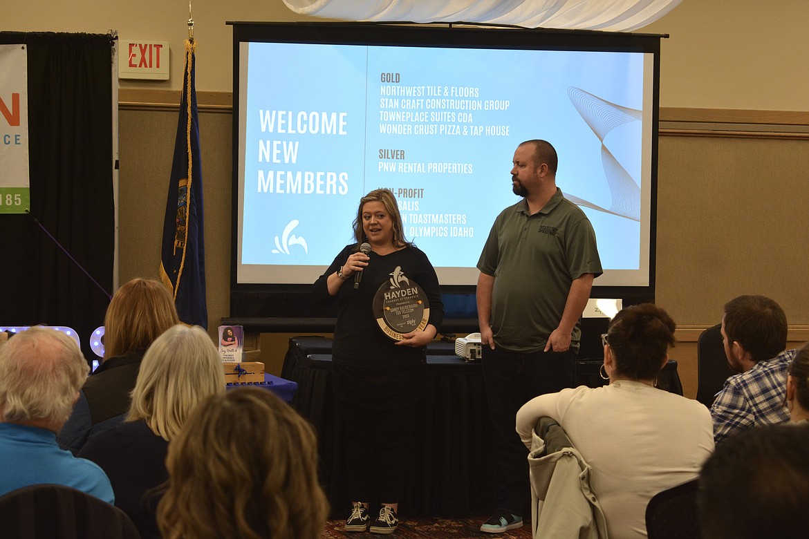 Sandy Raudebaugh of TDS Telecommunications accepted the Business of the Year Award from Matt Alexander, general manager of Findlay Stadium Stateline Speedway.