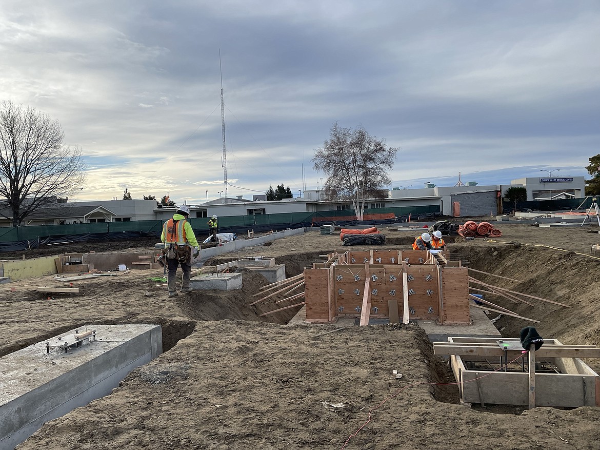 Construction workers prepare the foundation at the Quincy hospital site.