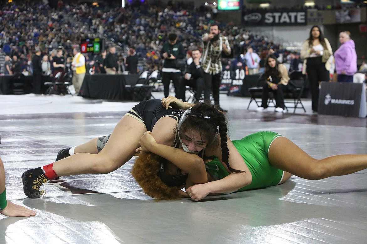 Royal senior Emma Villa, in black, works to get her opponent on her back at the 2023 Mat Classic.