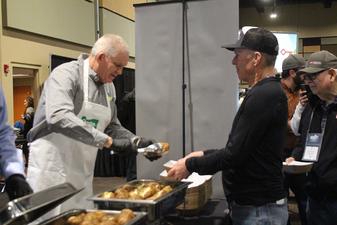 Oregon Potato Commissioner Rob Wagstaff serves potatoes at the baked potato bar at the annual Washington-Oregon Potato Conference in Kennewick last week.