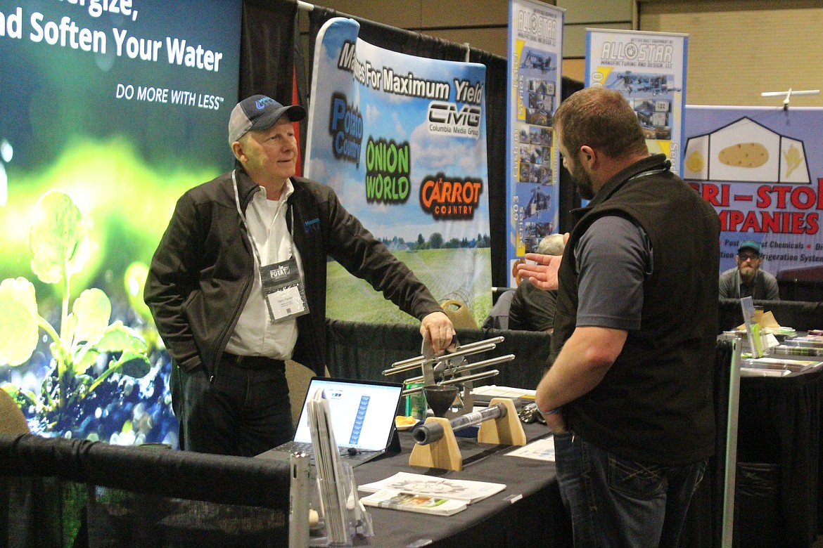 A vendor chats with a customer at the potato conference, sponsored by the potato commissions from Washington and Oregon.