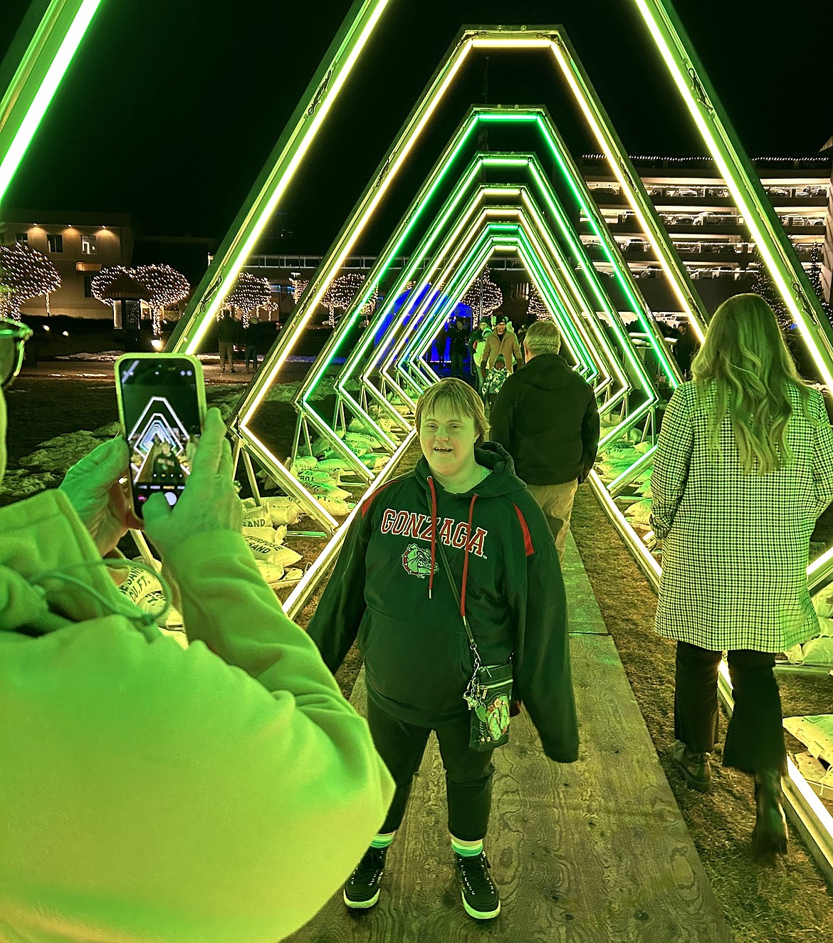 Tara Kopczynski smiles in The Tunnel in front of The Coeur d'Alene Resort on Friday, opening night of Winter Lights.