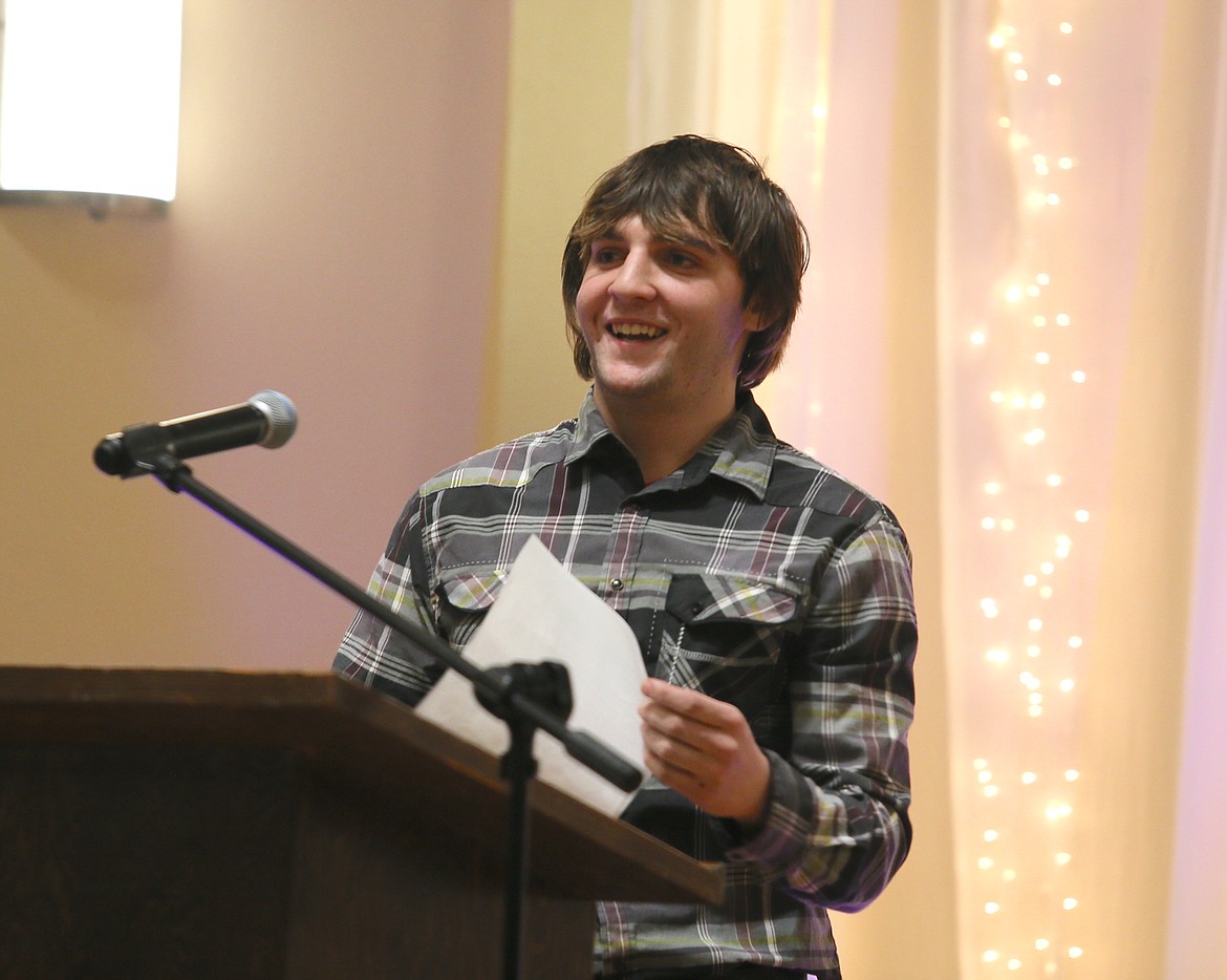 Coeur d'Alene Boys and Girls Club member David Catalone smiles as he concludes reading his essay Thursday evening during the Boys and Girls Club of Kootenai County's Youth of the Year event in Post Falls.