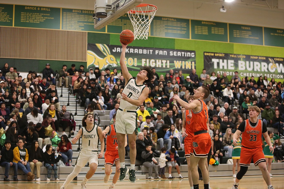 Quincy senior Dom Trevino (0) goes up for a layup in the first quarter against Cashmere Thursday.