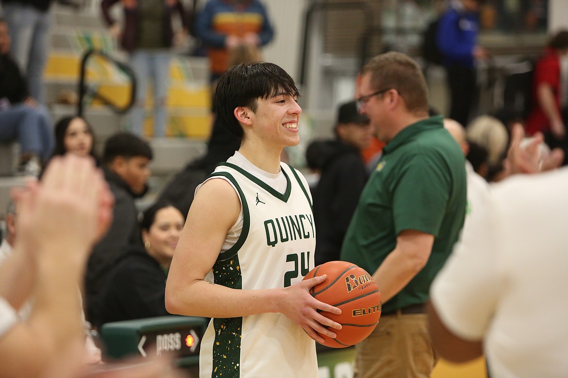 Quincy senior Julian Ibarra smiles for photos after the Jackrabbits defeated Cashmere Thursday night. Ibarra scored his 1,000th career point during the third quarter.