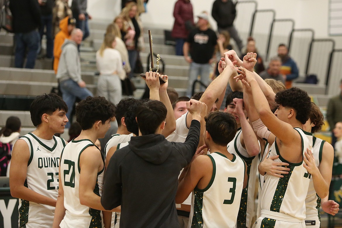 Quincy players celebrate after defeating Cashmere 70-49 Thursday night, winning their third straight Caribou Trail League title.