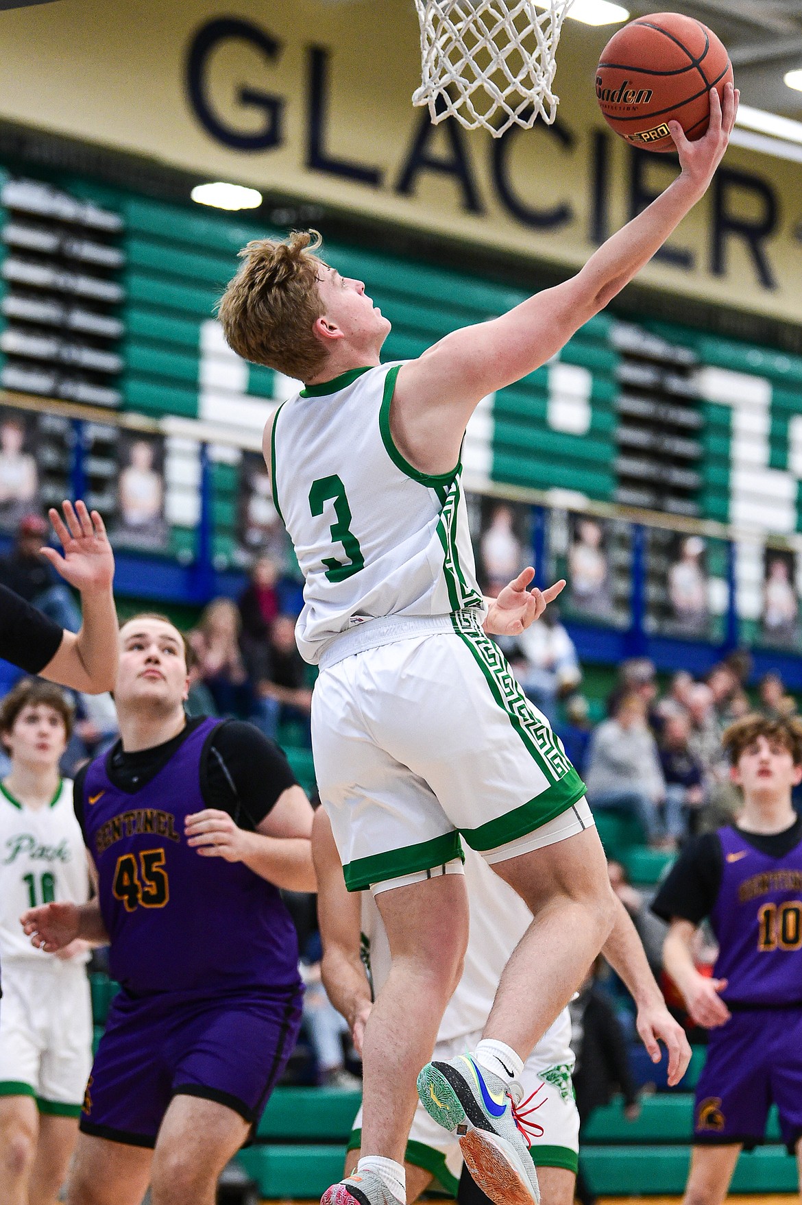 Glacier's Luke Nikunen (3) drives to the basket for a reverse layup in the first half against Missoula Sentinel at Glacier High School on Saturday, Jan. 27. (Casey Kreider/Daily Inter Lake)