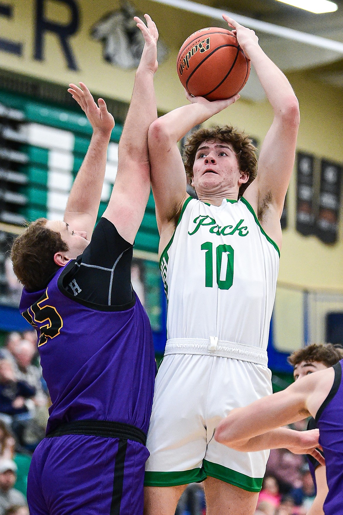 Glacier's Brantly Salmonsen (10) shoots over Missoula Sentinel's Holter Schweyen (45) in the first half at Glacier High School on Saturday, Jan. 27. (Casey Kreider/Daily Inter Lake)