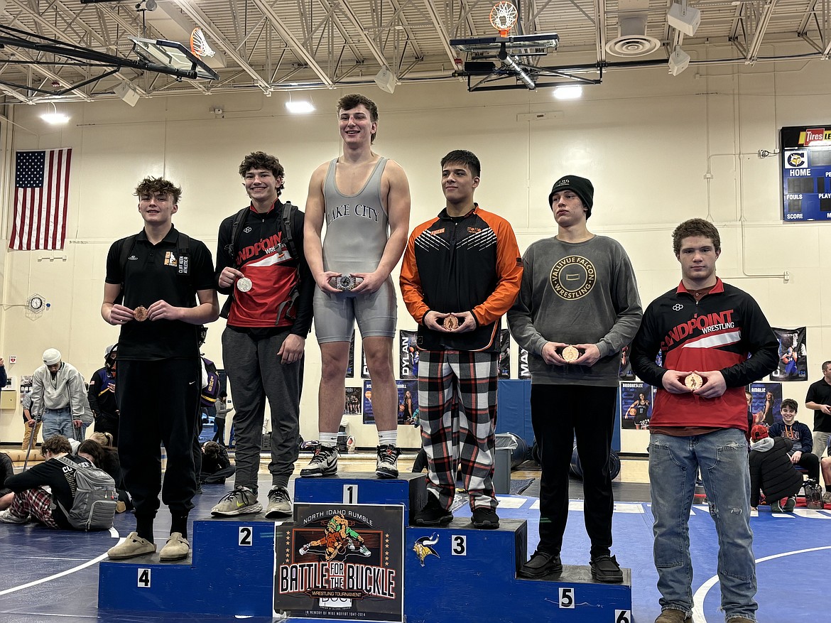 Sandpoint's Jorden Tyler (second place) and Jeremiah Palmer (sixth place) hold their awards while standing on the podium at the North Idaho Rumble held at Couer d'Alene High on Saturday.