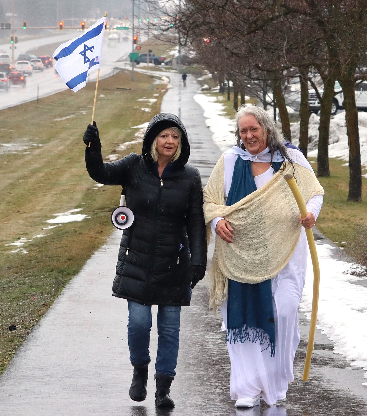 Karen Campbell, left, and Ginger Horvath walk along U.S. 95 during a rally and march in support of Israel on Saturday.