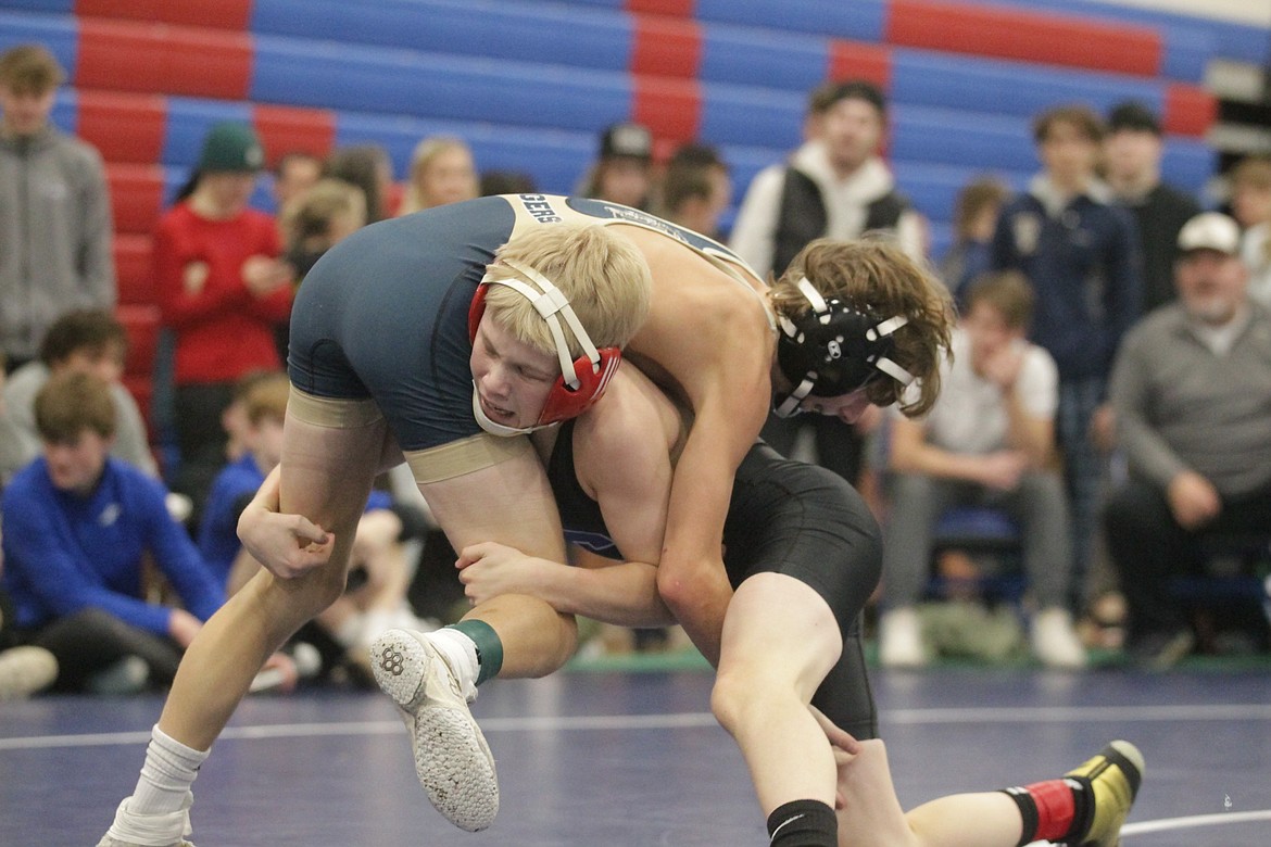 JASON ELLIOTT/Press
Coeur d'Alene sophomore Rocco White takes down Timberlake sophomore Sawyer Huston during the 98-pound championship match in the North Idaho Rumble on Saturday at Coeur d'Alene High.