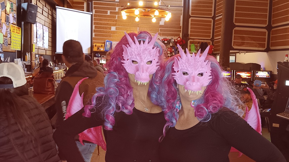 Shela Glasgow, left, and Jodi Bentley played their part of the $1,000 Super Poker Ride in Haugan over the weekend. The theme was Vikings and Dragons with a little over 200 snowmobilers taking part in the 35-mile course. (Monte Turner/Mineral Independent)