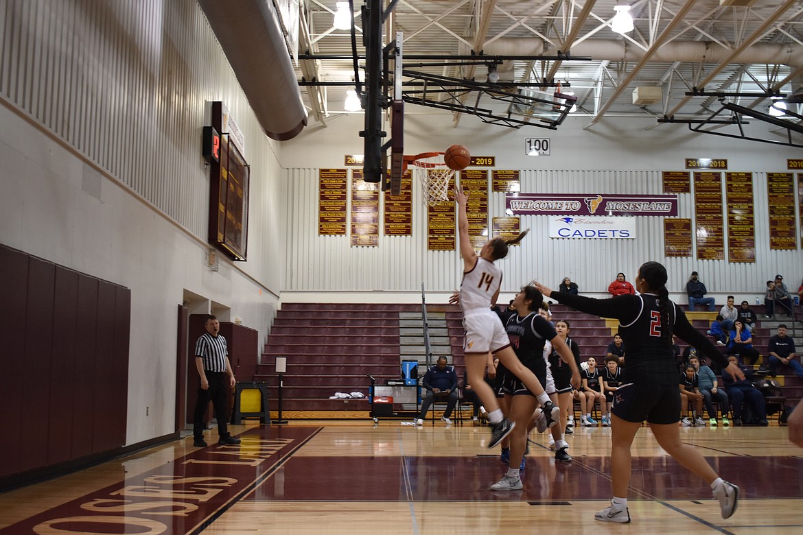 Moses Lake senior Lexi Cox (14) shoots one of her many layups in the Mavericks’ game against Eisenhower Saturday.