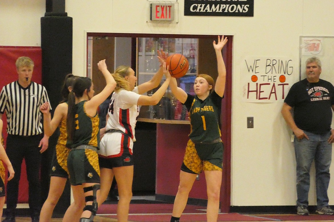 Hot Springs senior Lauryn Aldridge (34, white jersey) is guarded by St. Regis guard Shannon Todd during their game Thursday evening in Hot Springs. (Chuck Bandel/VP-MI)