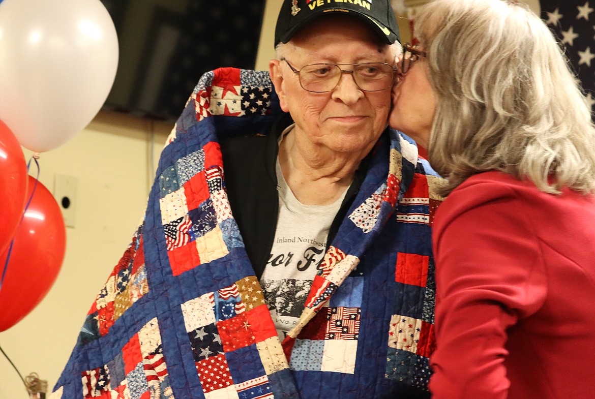 Duane Severson gets a kiss from his daughter, Lona Rudd, following the Quilts of Valor presentation at Brookdale Coeur d'Alene on Saturday.