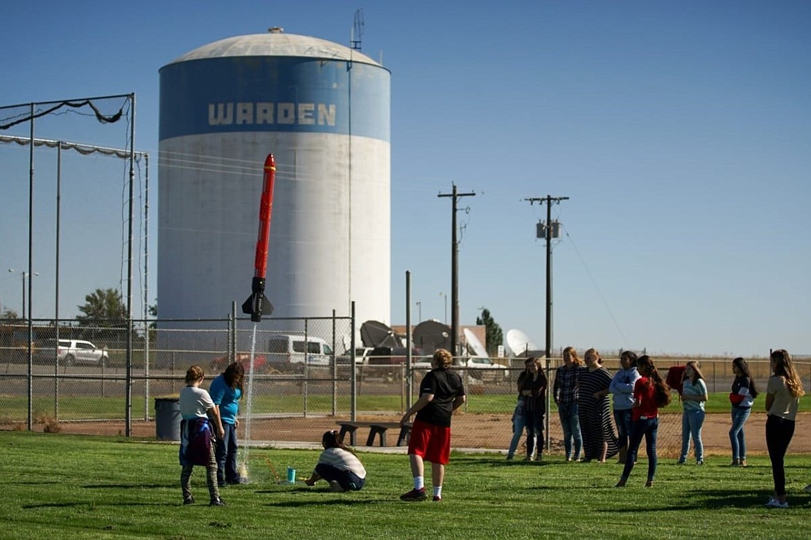 Warden Middle School students shoot a rocket into the air during a school activity in front of the Warden water tower next to the Warden School District campus. Finance Director Kassandria Rouleau discussed the district’s finances for the 2022-23 school year during Thursday’s regular school board meeting.