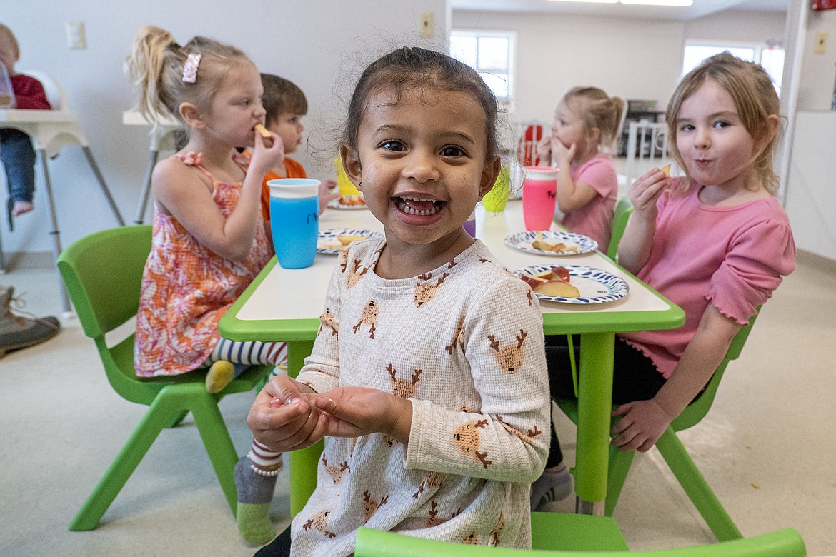 Janessa Kowalski (center) pauses during snack time to pose for the camera at the Kids Corral on Nucleus Avenue Monday, Jan. 22. (Avery Howe photo)