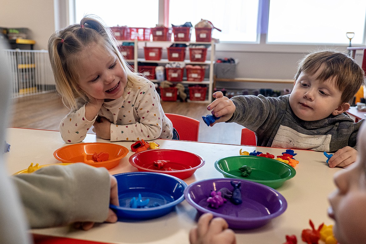 Anna Sorenson and Crew Butcher sort colored toys at the Kids Corral on Monday, Jan. 22. (Avery Howe photo)