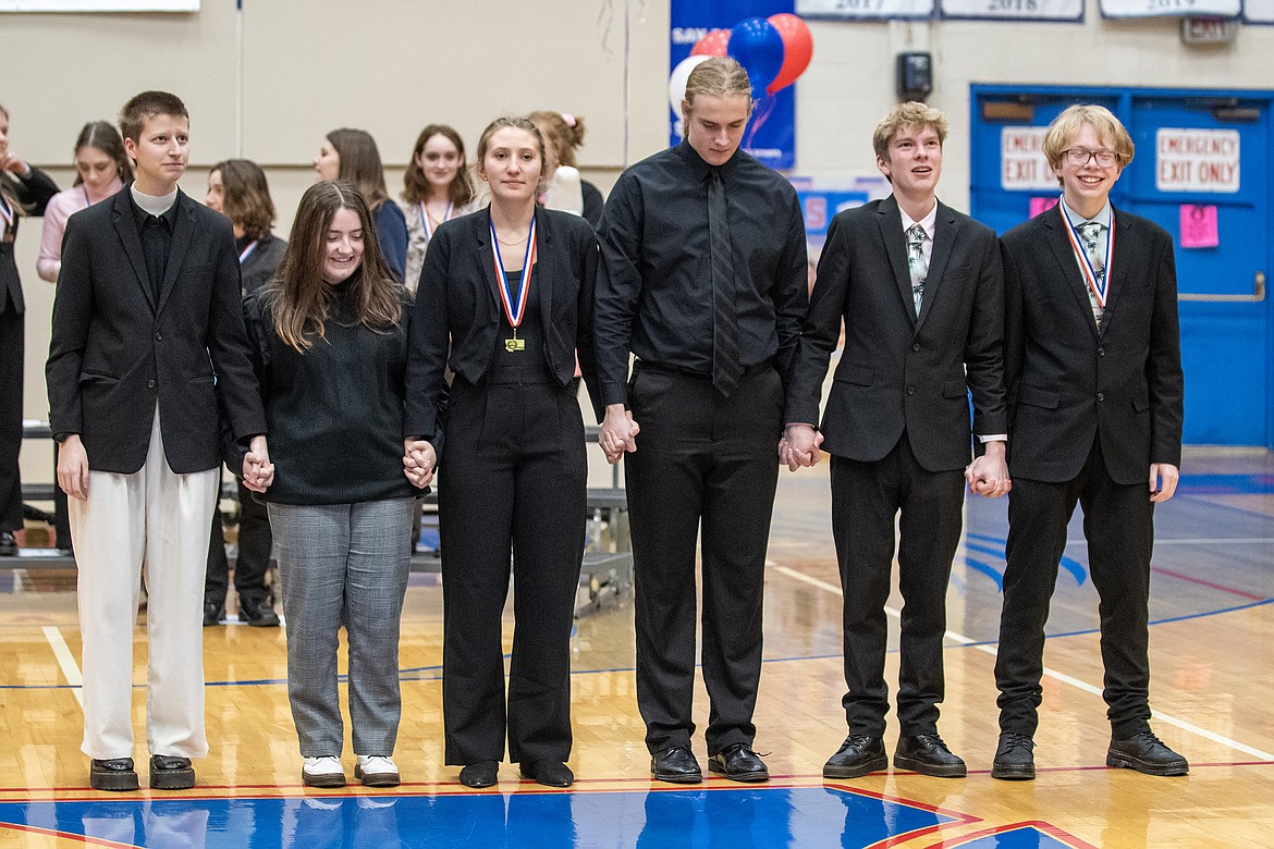 Ruby Davis, Makinzie Taylor, Kajsa Mohr, Lucas Counts, Carson Settles and Reed Wollenzien hold hands as they wait for the winners of DUO Interpretation in Columbia Falls Saturday, Jan 27. Columbia Falls took the top three spots, with Davis and Taylor in third, Mohr and COunts second and Settles and Wollenzien first. (Avery Howe photo)