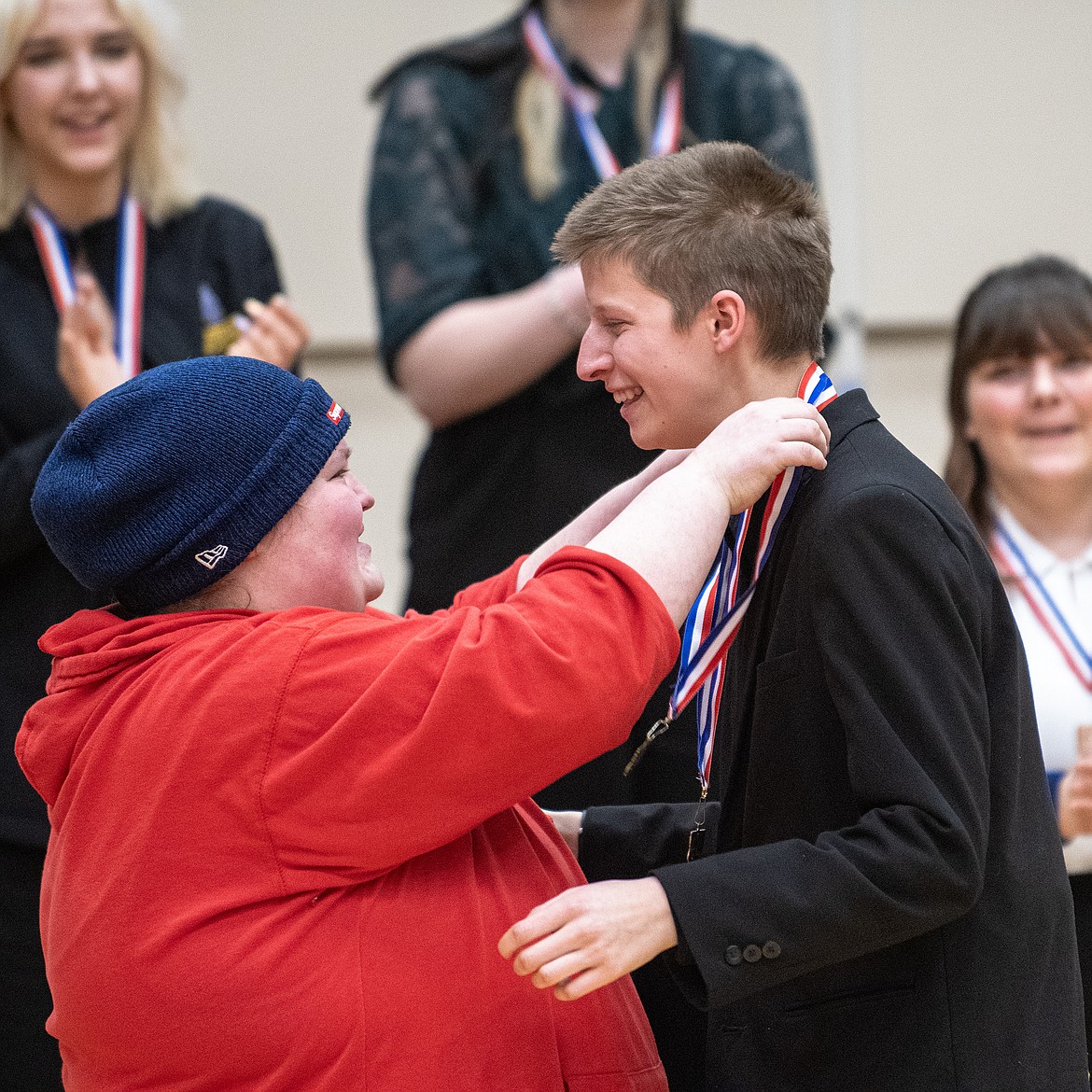 Ruby Davis (right) receives her first place medal in Informative from coach Alix Major at the State A Speech Tournament in Columbia Falls Saturday, Jan 27. (Avery Howe photo)