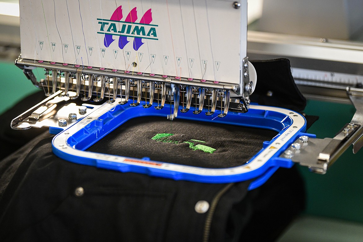 A logo is stitched onto a jacket using an industrial embroidery machine at Cajun Designs in Kalispell on Tuesday, Jan. 30. (Casey Kreider/Daily Inter Lake)