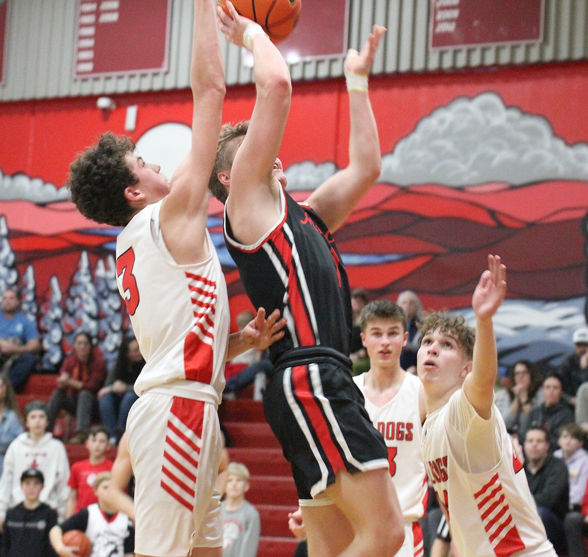 Sandpoint freshman Knox Williams blocks Moscow's Cody Wilson from behind at Les Rogers Court Tuesday night.