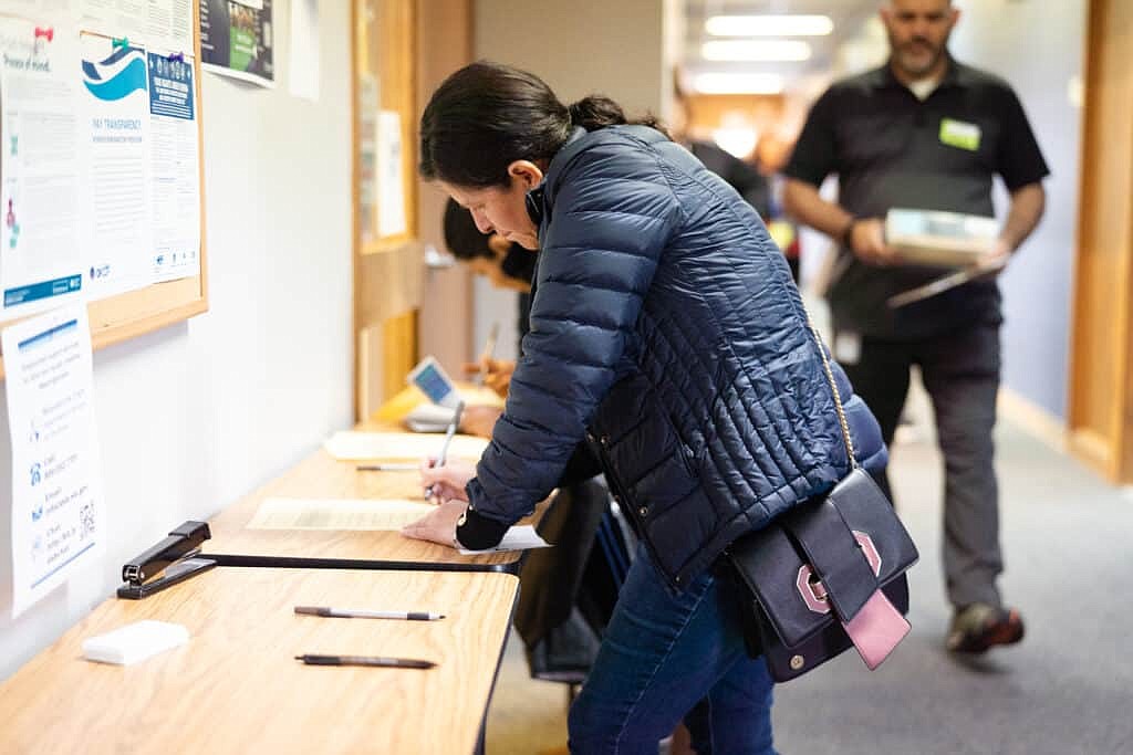 Job seekers fill out forms at the first SkillSource Othello job fair Friday at the organization’s Thieme Career Development Center.