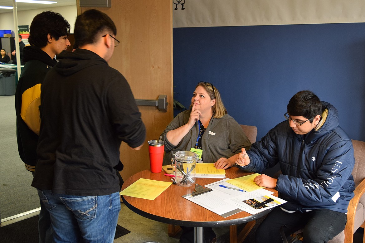 SkillSource Adult Training Manager Emily Anderson, seated left, speaks to and welcomes event attendees at Friday’s Othello hiring fair at SkillSource’s Othello location.