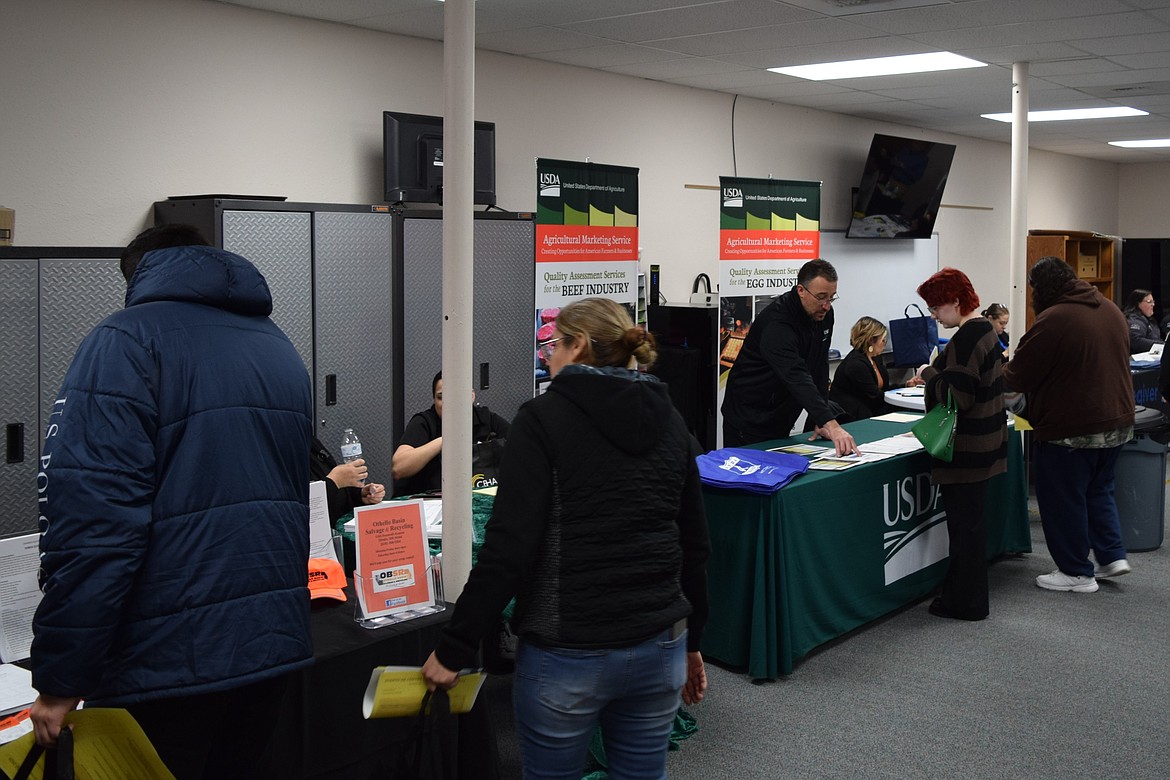 Job seekers at Friday’s Othello job fair, held by SkillSource, speak with various businesses for job leads and networking opportunities. SkillSource Adult Training Manager Emily Anderson said a significant number of jobseekers walked out with leads or interviews.