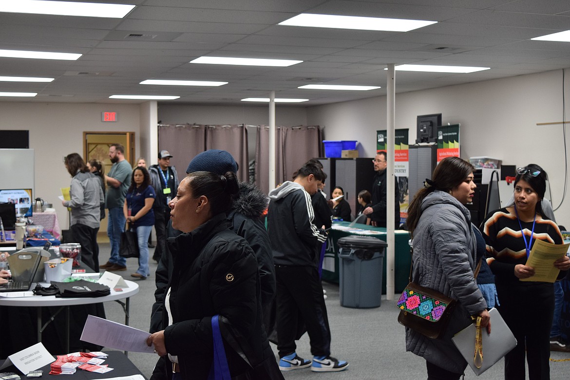 Job seekers visit booths run by local businesses at SkillSource’s Othello hiring event Friday. SkillSource Adult Training Manager Emily Anderson said almost 160 jobseekers participated in the event.