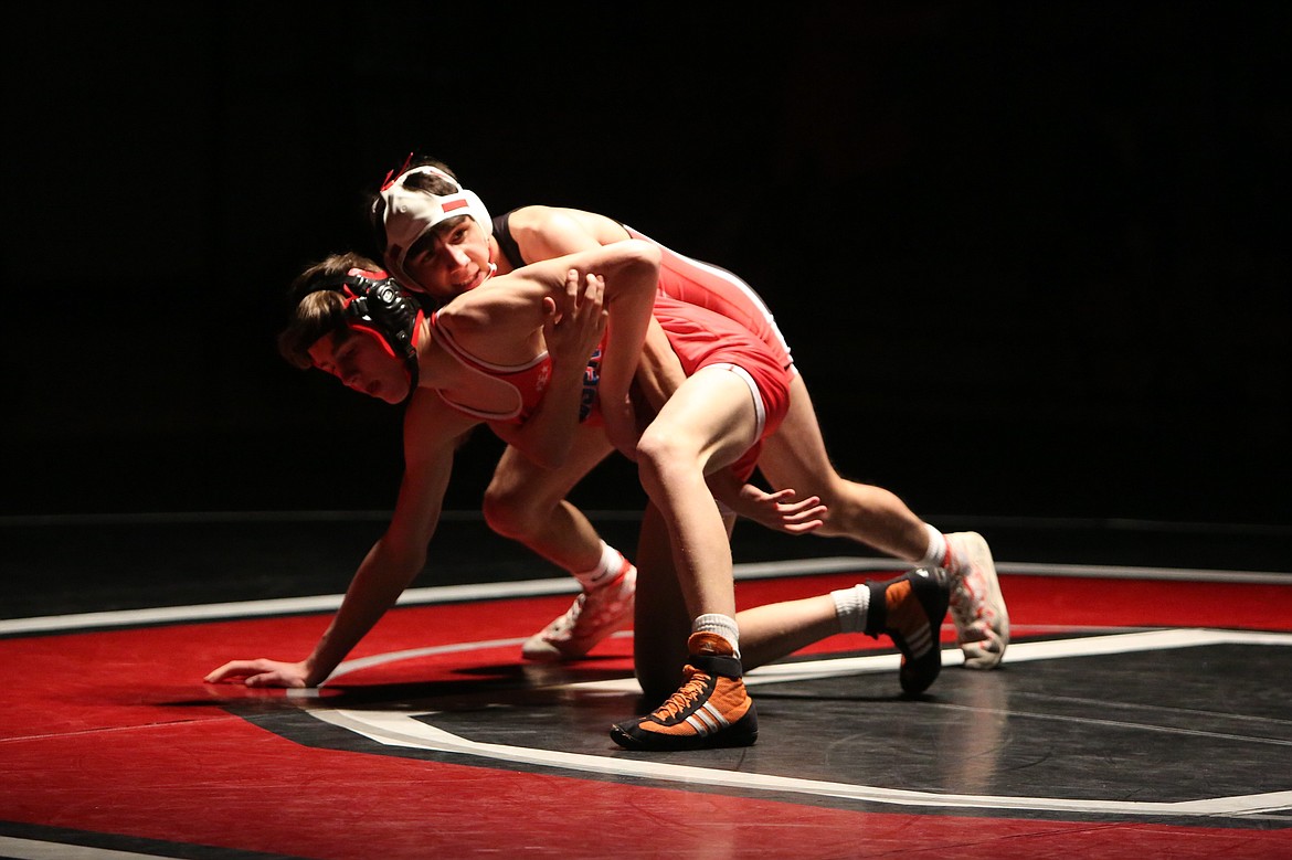 Othello senior Isaac Campos, top, was one of five Huskie seniors honored at Thursday’s dual against Ephrata.