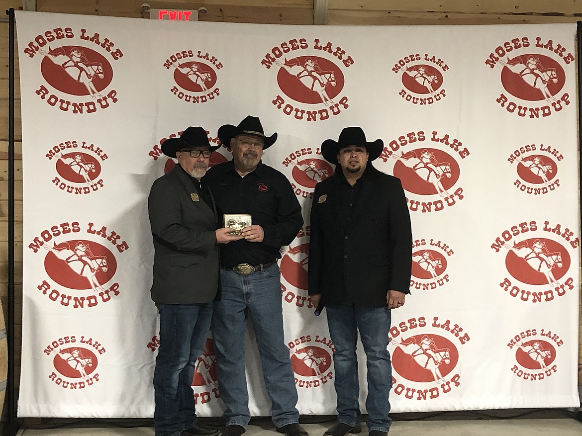 Outgoing President Stuart Platt (center) receives his President buckle from outgoing VP Stan Cafferty (left) and incoming VP Alex Alvarado (right).