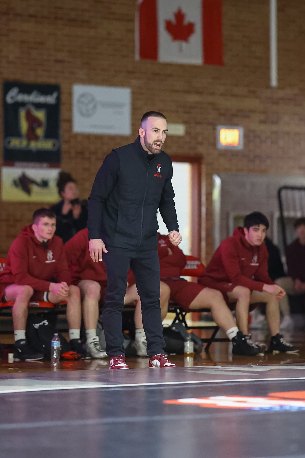 KYLE DISHAW PHOTOGRAPHY
North Idaho College wrestling coach Derrick Booth shouts instruction during Wednesday's match against Clackamas at Christianson Gymnasium.