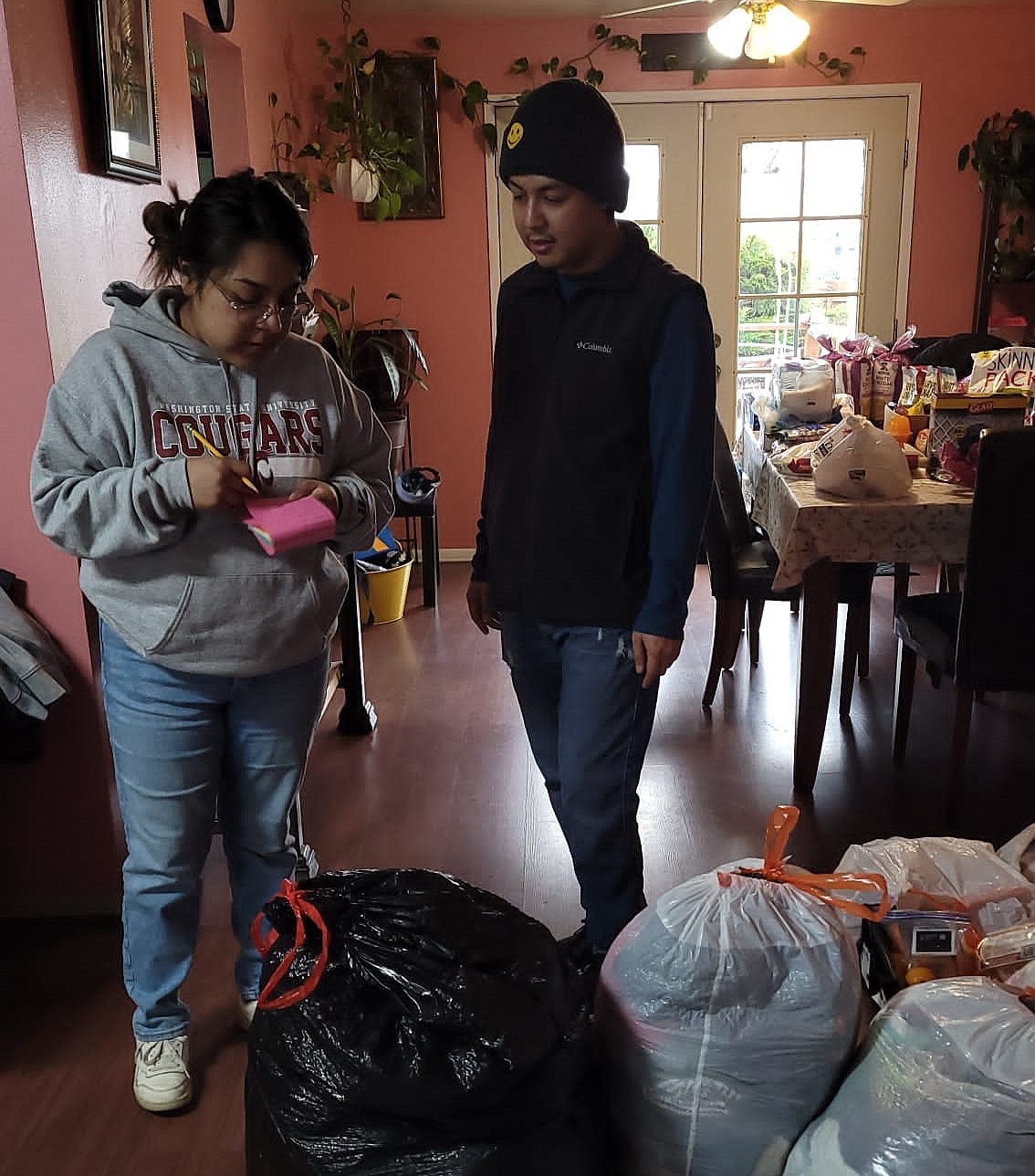 Volunteers gather supplies for the Othello outreach program “One Day at a Time.” Volunteers from both Othello and Tri-Cities meet every Saturday to pass out food and supplies to community members in need.