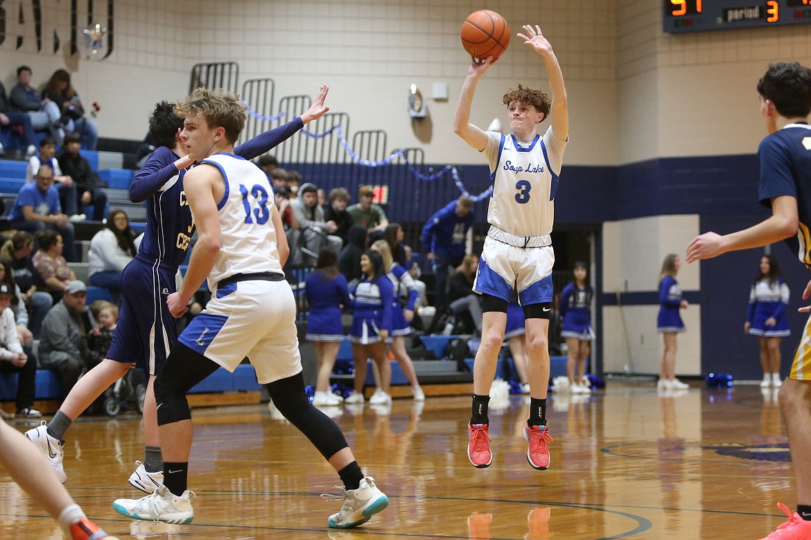 Soap Lake senior Trey Landdeck (3) shoots a three-pointer in the second half against Cascade Christian.