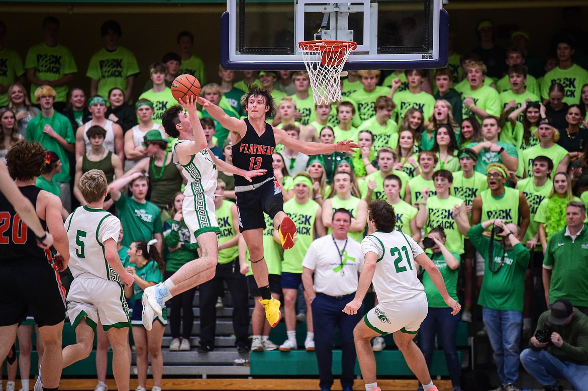 Glacier's Noah Cummings (40) is defended by Flathead's Lyric Ersland (13) on his way to the basket in the second half at Glacier High School on Thursday, Feb. 1. (Casey Kreider/Daily Inter Lake)