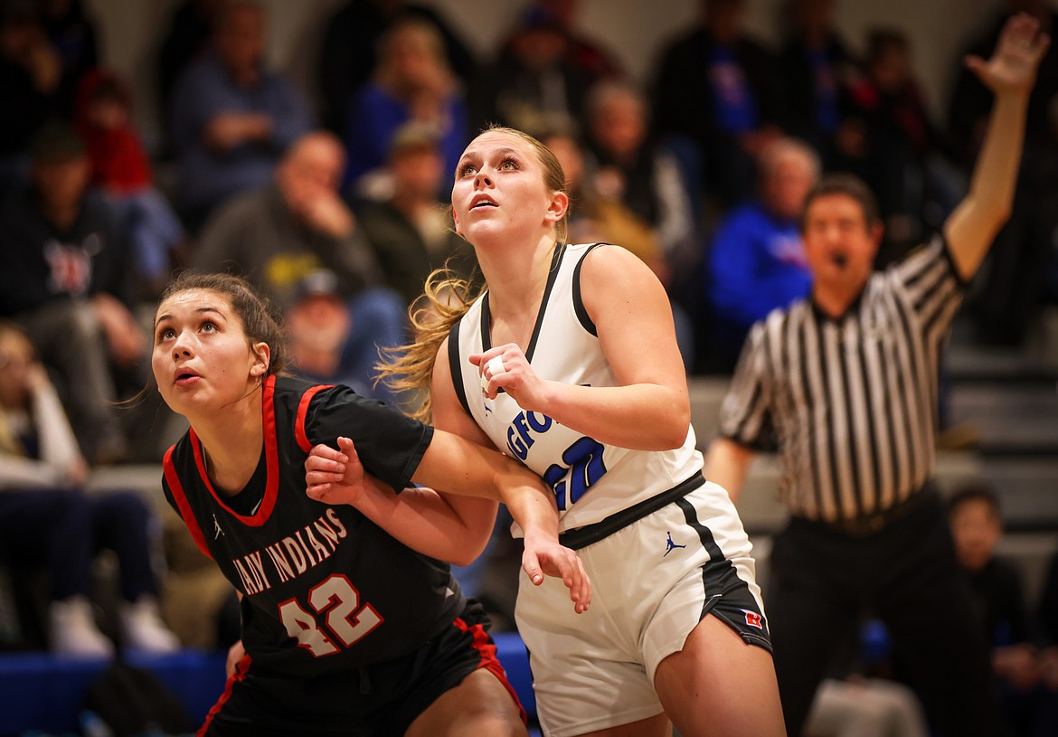 Afton Lambrecht battles Browning’s Josey Micheal for a rebound last week. (Jeremy Weber/Bigfork Eagle)