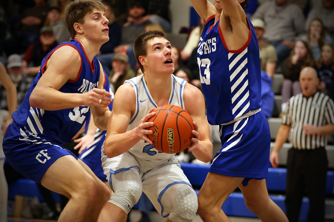 Asher Knopik uses a pump fake to get past the Wildcat defense for two of his 26 points Saturday. (Jeremy Weber/Bigfork Eagle)