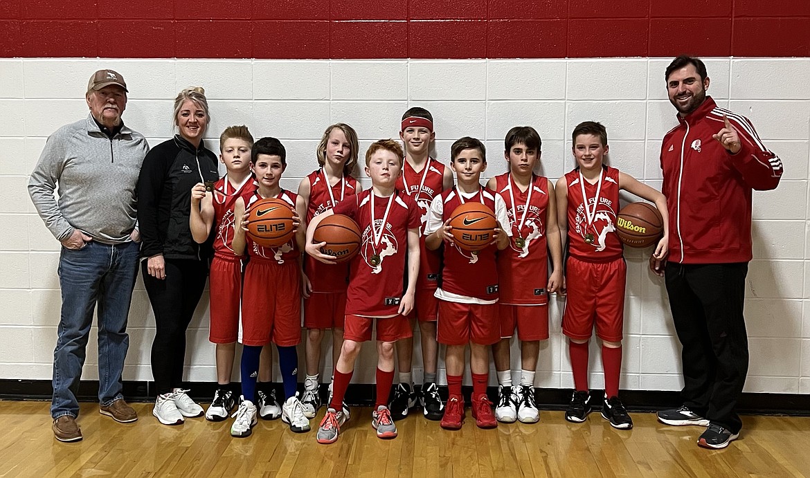 The Sandpoint Future fourth grade boys pose with their first place medals from the Sandpoint Future Invitational. From left, assistant coach Joe Mire, head coach Ashleigh Mire, Will Hawn, Emerson Marshall, Mac Driggs, Harper Fields, Garrison Markwardt, Greyson Reid, Rowin Macdonald, Sam Webb, and assistant coach Mat Macdonald