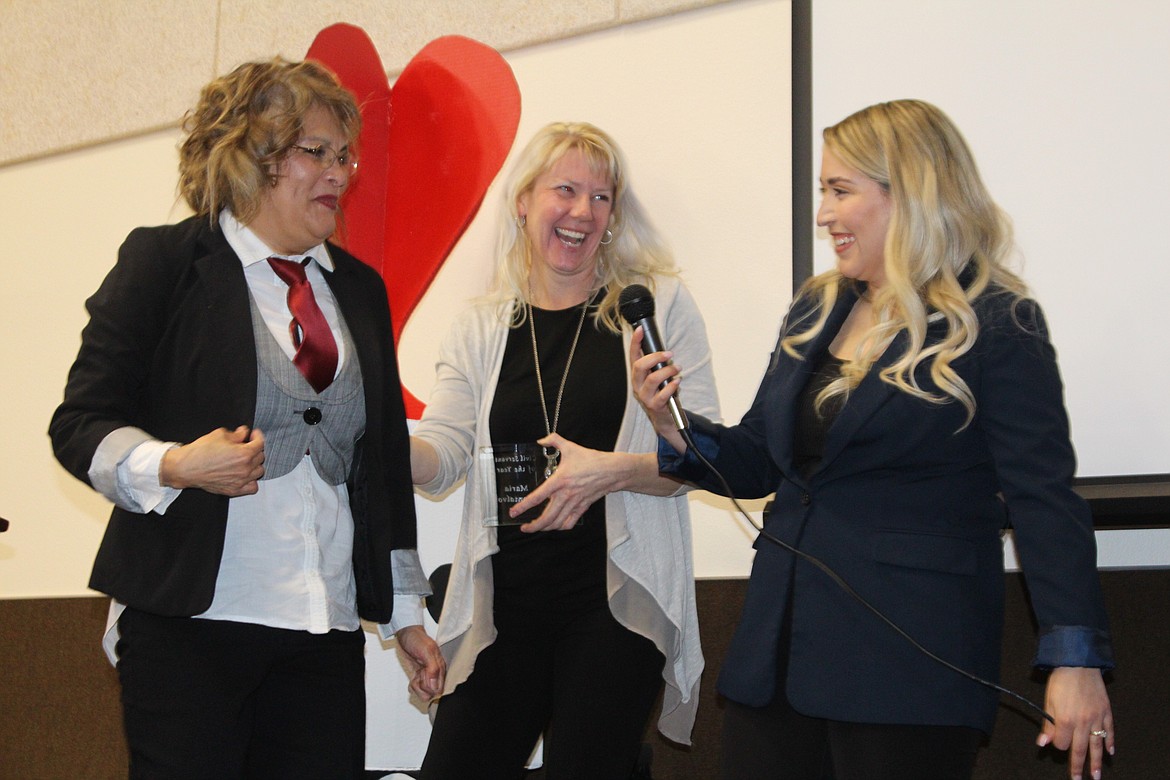 Othello resident Maria Montalvo, left, receives the 2023 Civil Servant of the Year award from Greater Othello Chamber of Commerce president Heather Miller, center, and former president Thalia Lemus, right.