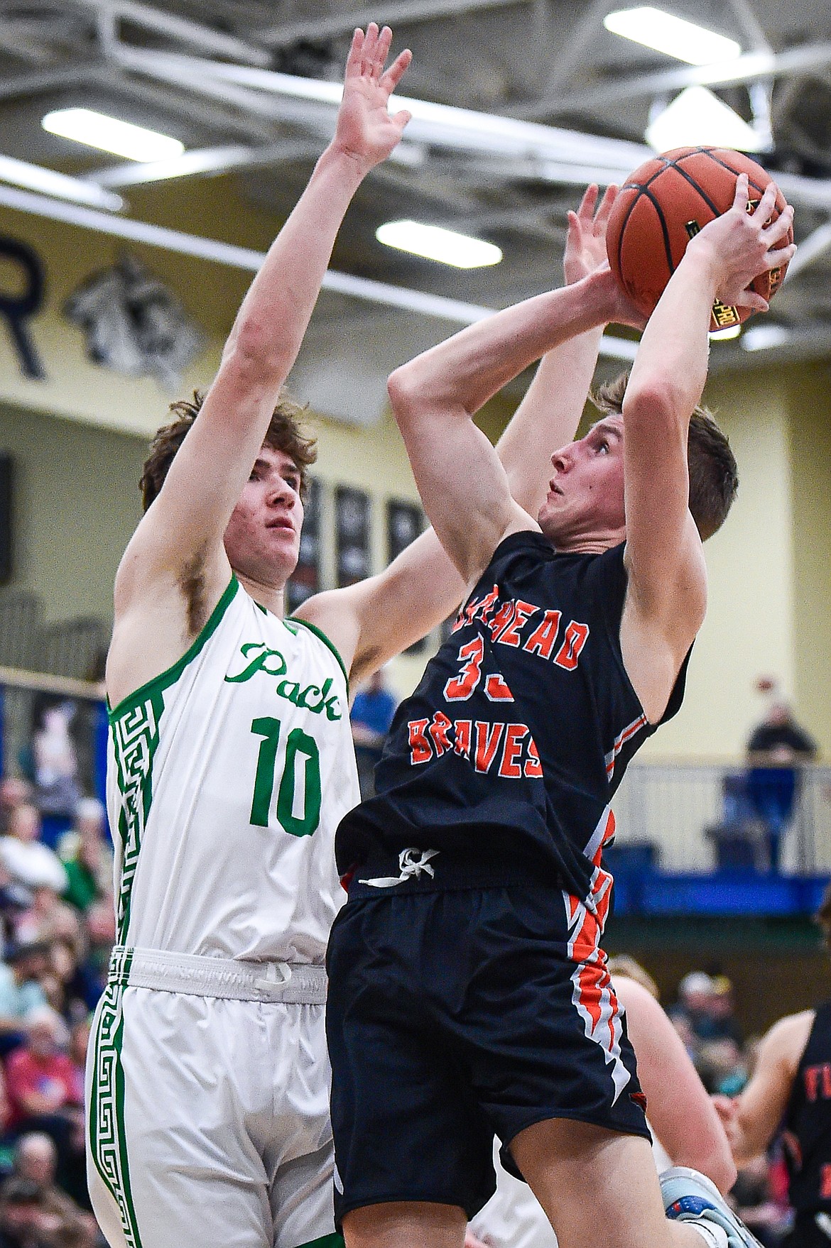 Flathead's Korbin Eaton (33) drives to the basket against Glacier's Brantly Salmonsen (10) in the second half at Glacier High School on Thursday, Feb. 1. (Casey Kreider/Daily Inter Lake)