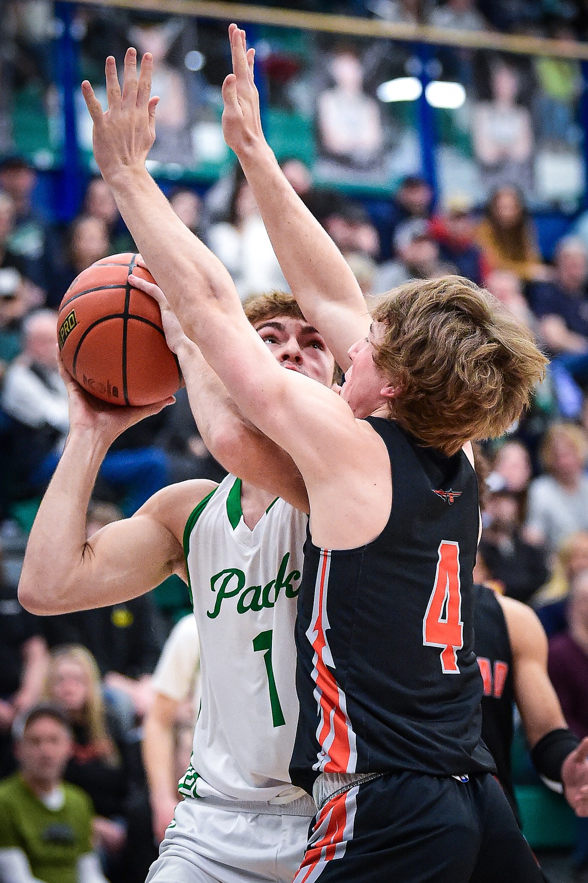 Galcier's Cohen Kastelitz (1) works under the basket against Flathead's Stephen Riley (4) in the first half at Glacier High School on Thursday, Feb. 1. (Casey Kreider/Daily Inter Lake)