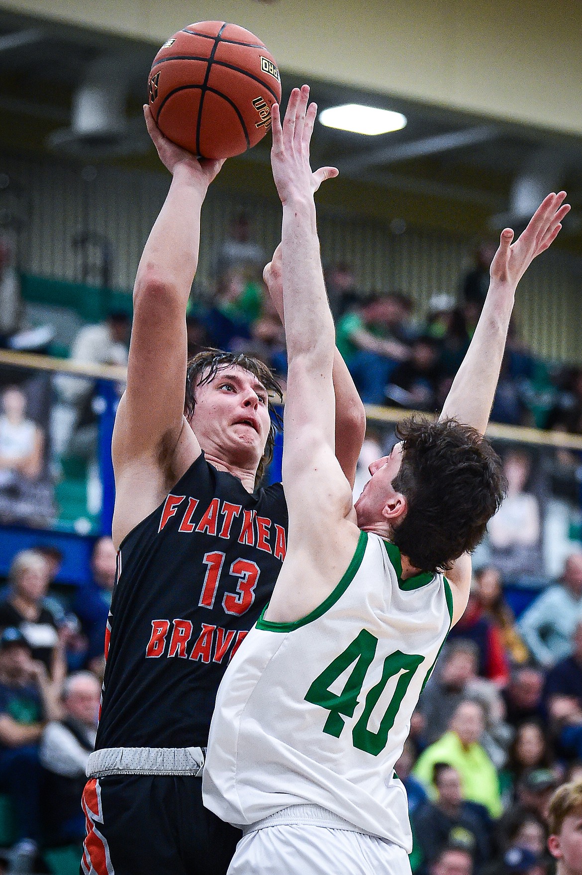 Flathead's Lyric Ersland (13) shoots over Glacier's Noah Cummings (40) in the second half at Glacier High School on Thursday, Feb. 1. (Casey Kreider/Daily Inter Lake)