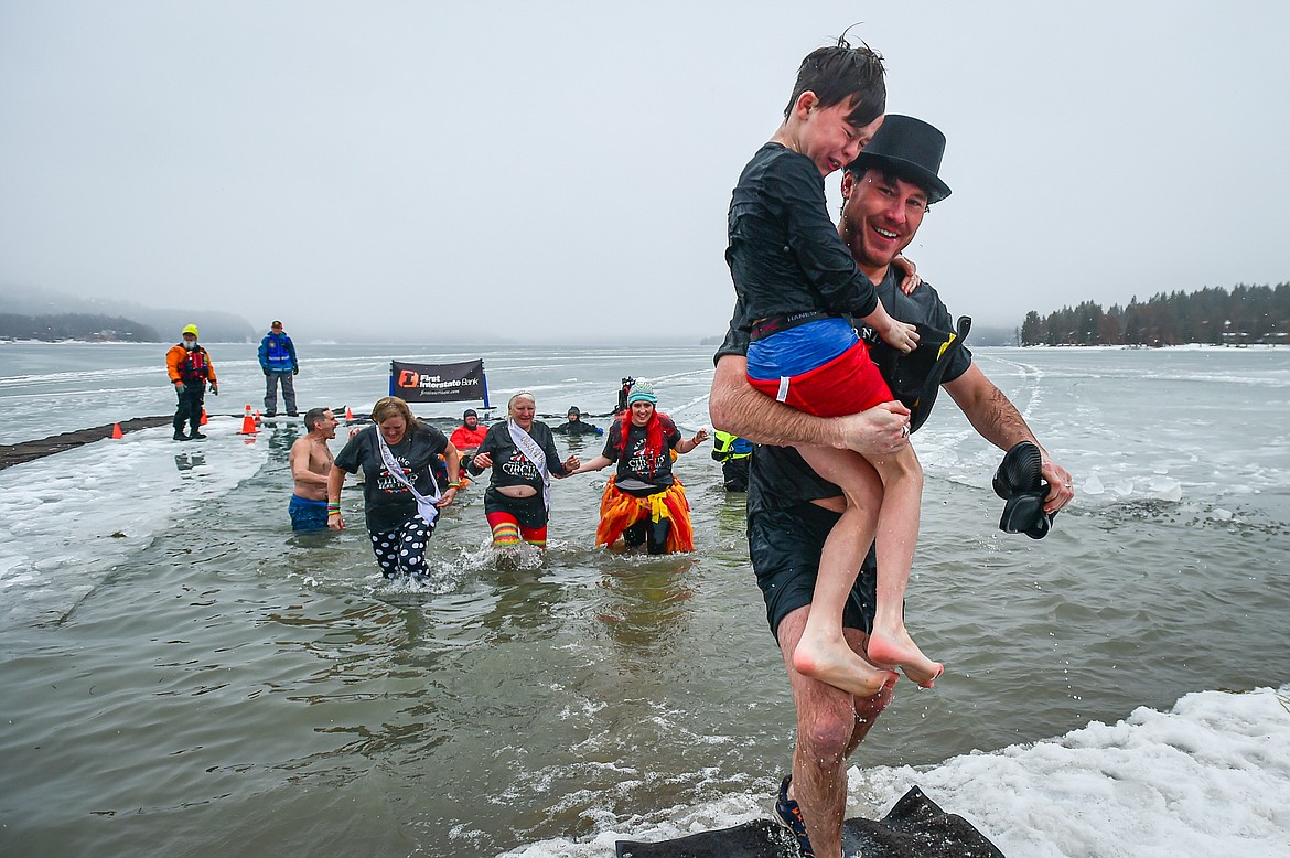 Participants step out of Whitefish Lake at the Penguin Plunge at City Beach in Whitefish on Saturday, Feb. 3. Organized by the Law Enforcement Torch Run, as part of the Whitefish Winter Carnival, the event raises money for Special Olympics Montana. (Casey Kreider/Daily Inter Lake)