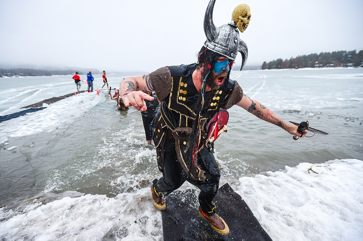 Participants step out of Whitefish Lake at the Penguin Plunge at City Beach in Whitefish on Saturday, Feb. 3. Organized by the Law Enforcement Torch Run, as part of the Whitefish Winter Carnival, the event raises money for Special Olympics Montana. (Casey Kreider/Daily Inter Lake)