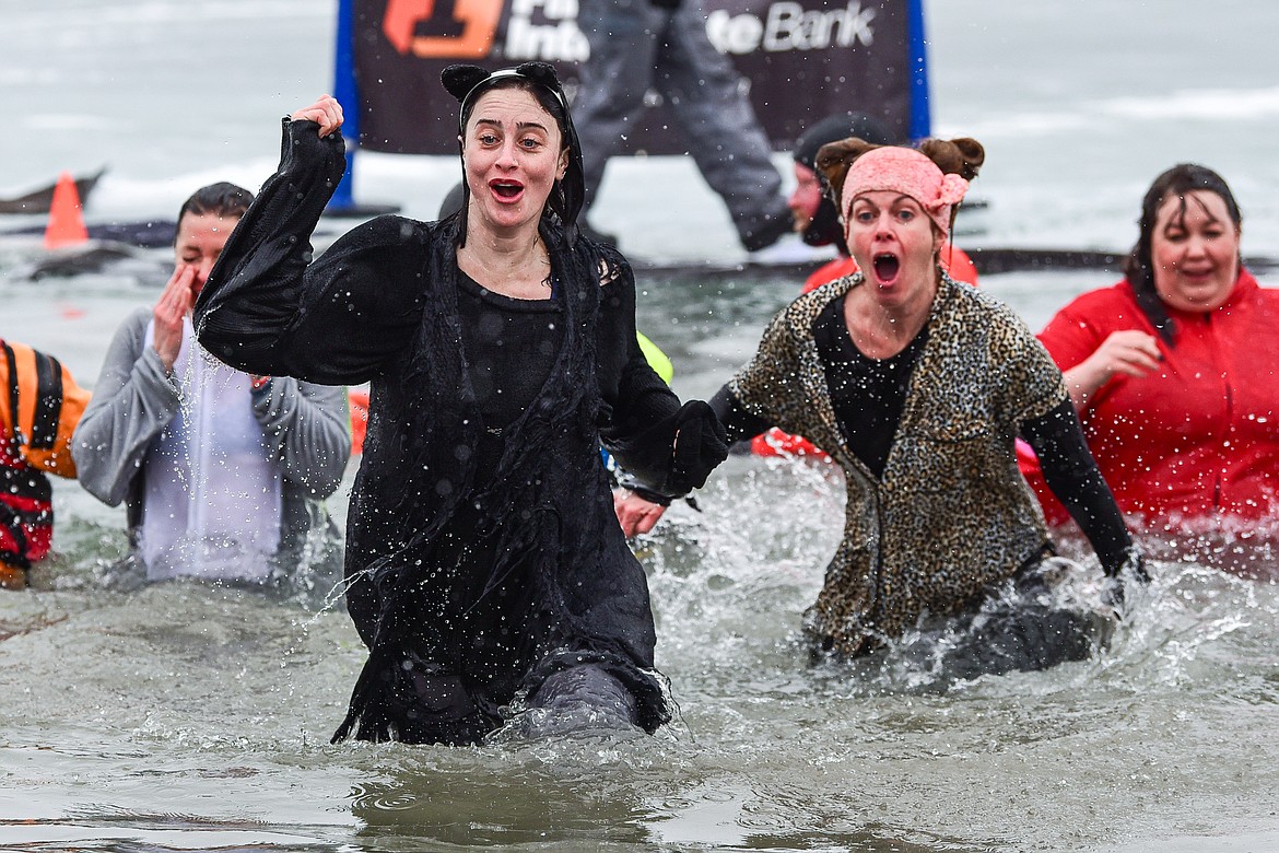 Participants react after jumping into Whitefish Lake at the Penguin Plunge at City Beach in Whitefish on Saturday, Feb. 3. Organized by the Law Enforcement Torch Run, as part of the Whitefish Winter Carnival, the event raises money for Special Olympics Montana. (Casey Kreider/Daily Inter Lake)