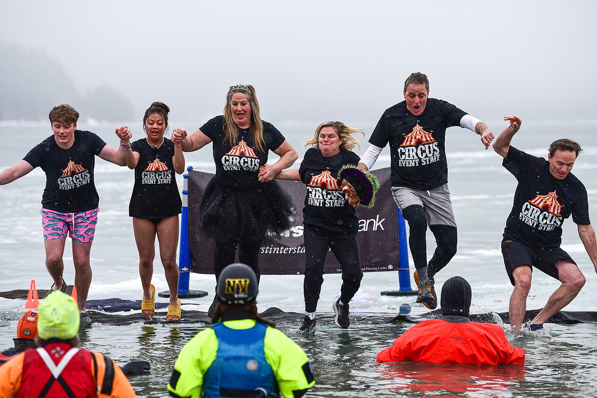 Participants jump into Whitefish Lake at the Penguin Plunge at City Beach in Whitefish on Saturday, Feb. 3. Organized by the Law Enforcement Torch Run, as part of the Whitefish Winter Carnival, the event raises money for Special Olympics Montana. (Casey Kreider/Daily Inter Lake)