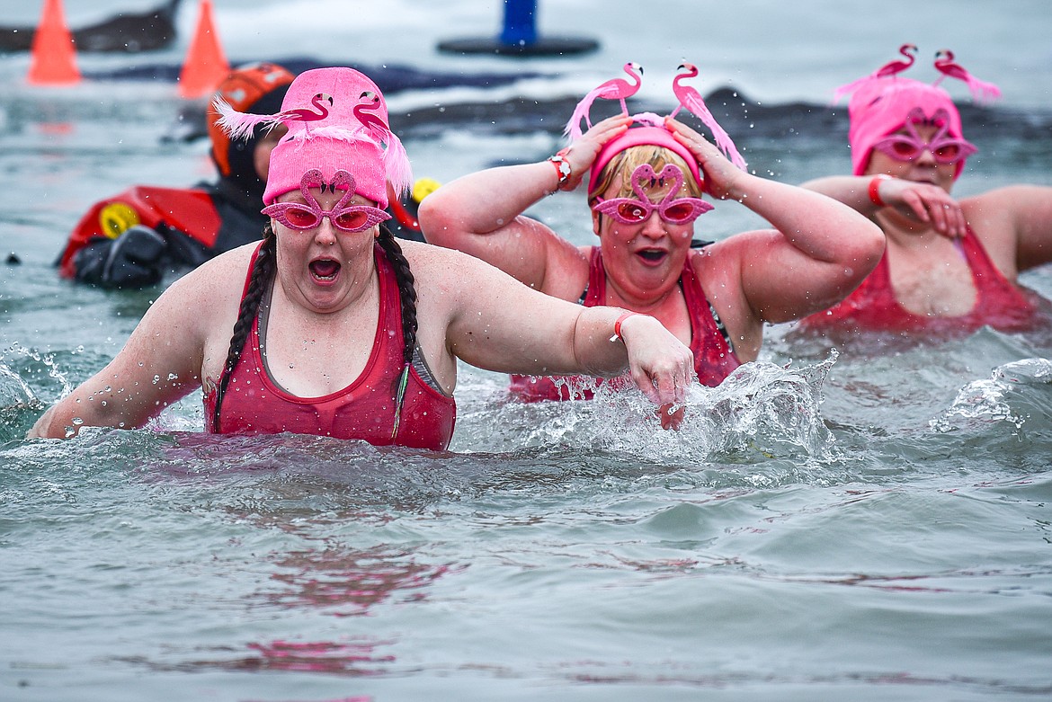 Participants react after jumping into Whitefish Lake at the Penguin Plunge at City Beach in Whitefish on Saturday, Feb. 3. Organized by the Law Enforcement Torch Run, as part of the Whitefish Winter Carnival, the event raises money for Special Olympics Montana. (Casey Kreider/Daily Inter Lake)