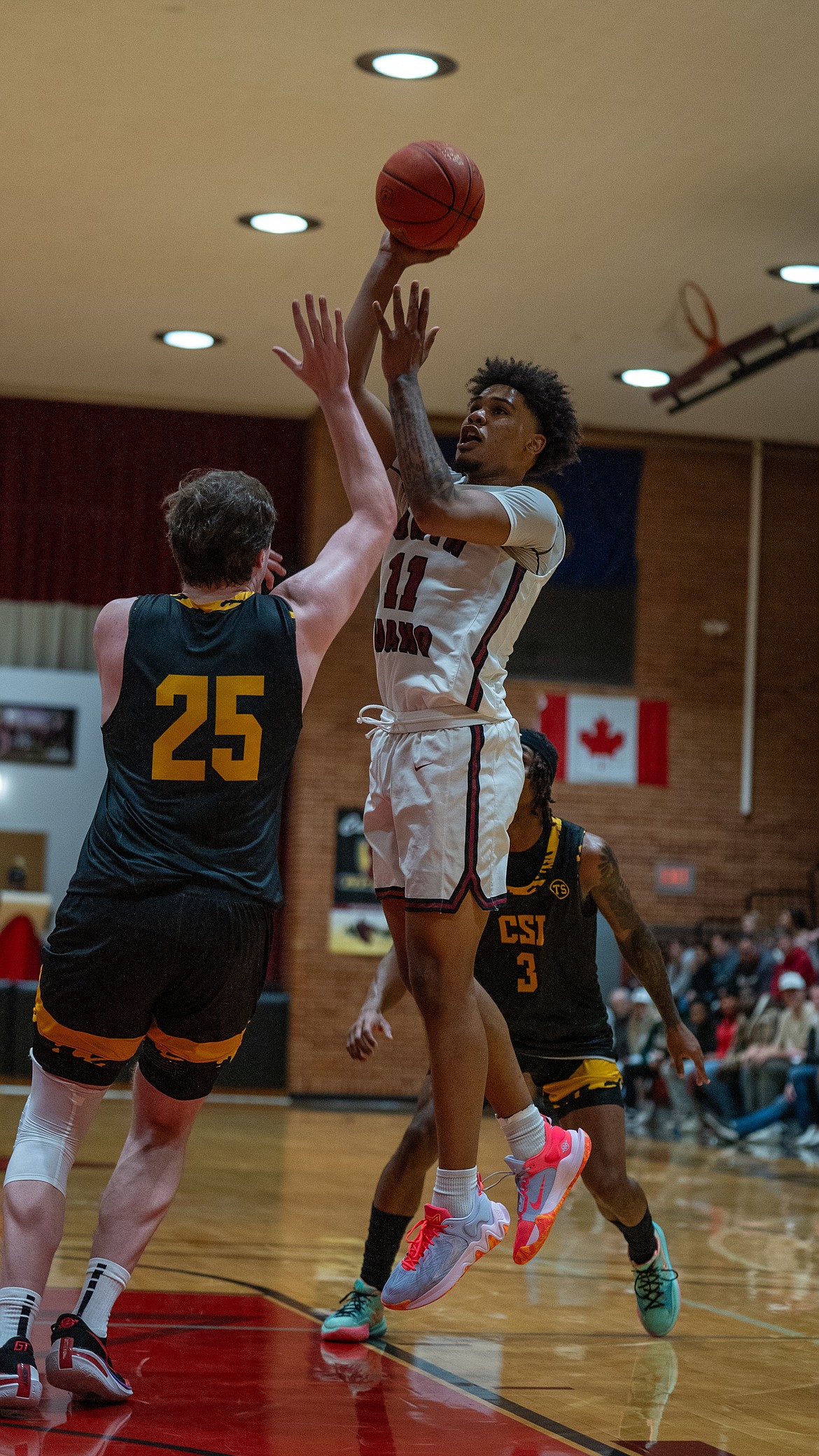 NIC ATHLETICS
North Idaho College sophomore guard Dante Sawyer shoots over Southern Idaho freshman Walker Timme during the first half of Saturday's Scenic West Athletic Conference game at Rolly Williams Court.