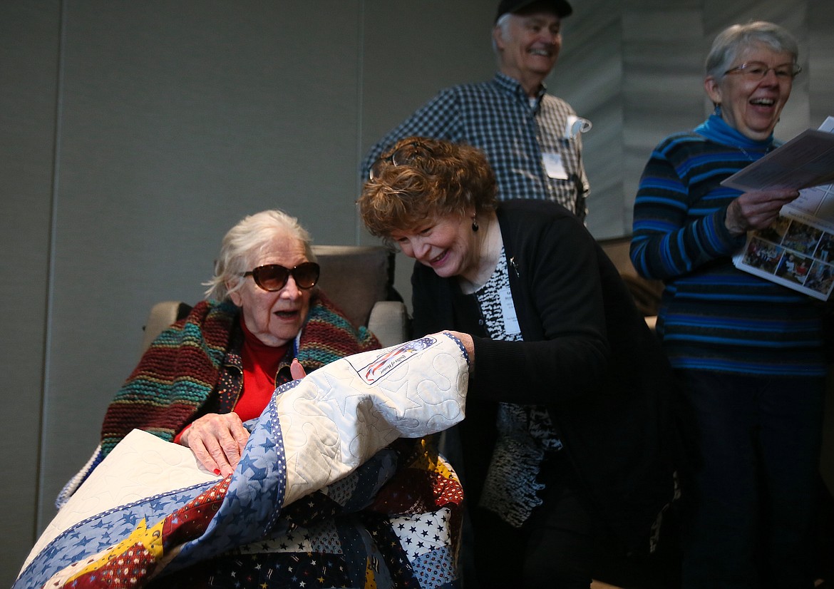 Katie McCollum presents Alice Flesher with a Quilt of Honor on her 102nd birthday Saturday. Flesher, a World War II veteran, was the first resident of the Idaho State Veterans Home in Post Falls, where her loved ones gathered to celebrate her birthday and honor her for her service.